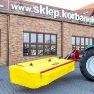 Żółto czerwona kosiarka fella prezentowana z ciągnikiem arbos serii 5000