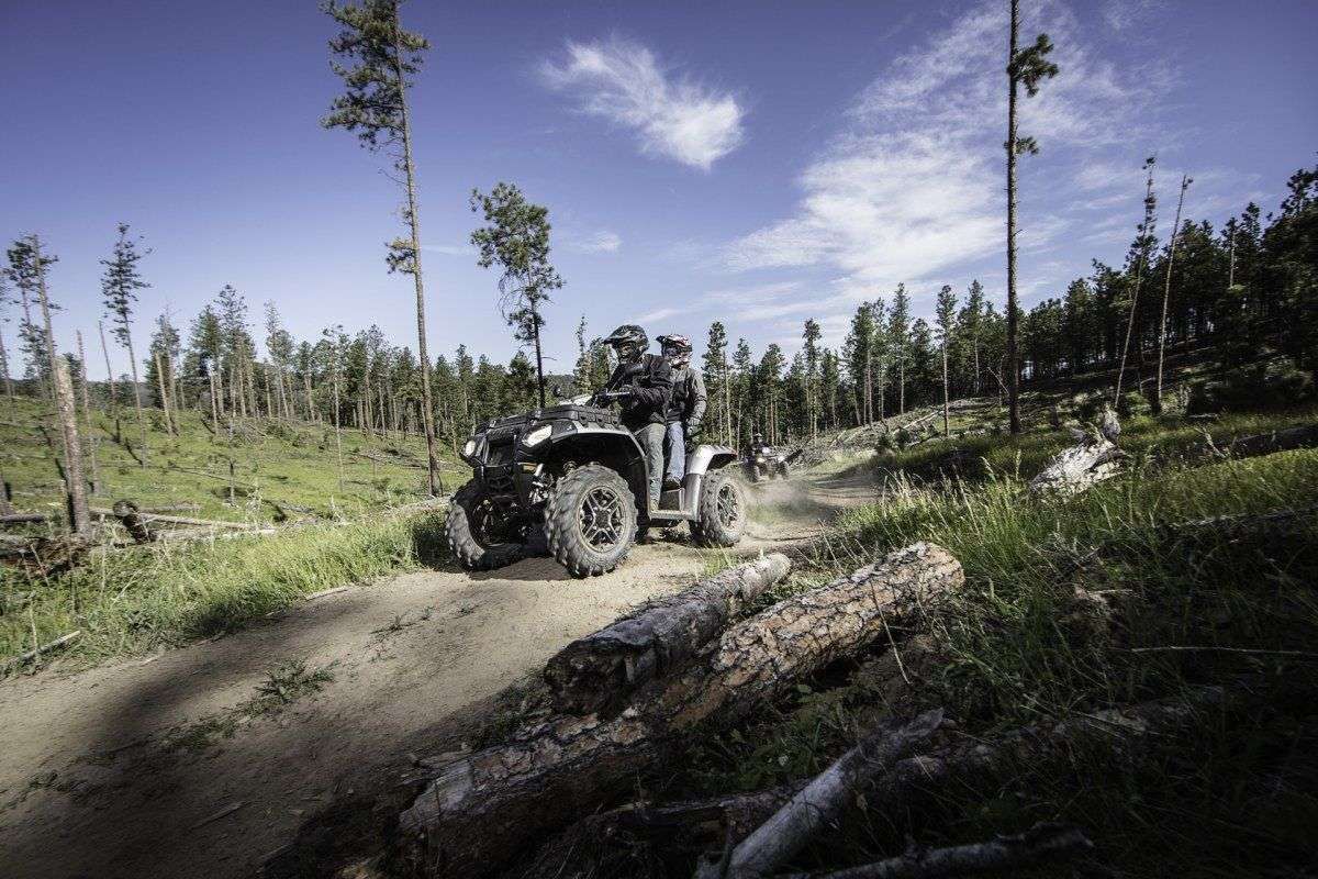 1000 XP Touring Sportsman Polaris Quad zjezdza w dół dwie osoby na pojezdzie